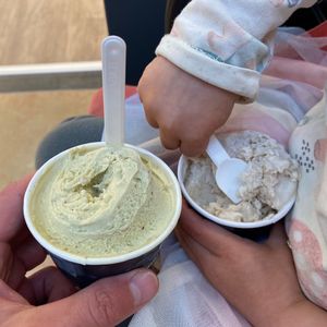 Two pairs of hands scooping gelato